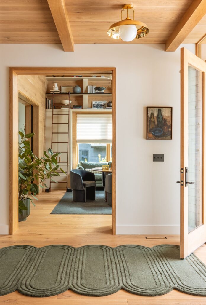 Emily-Henderson_River-House_Game-Room-Reveal_Wood-Paneling_Library-Ladder_Cozy-Den_1.jpg