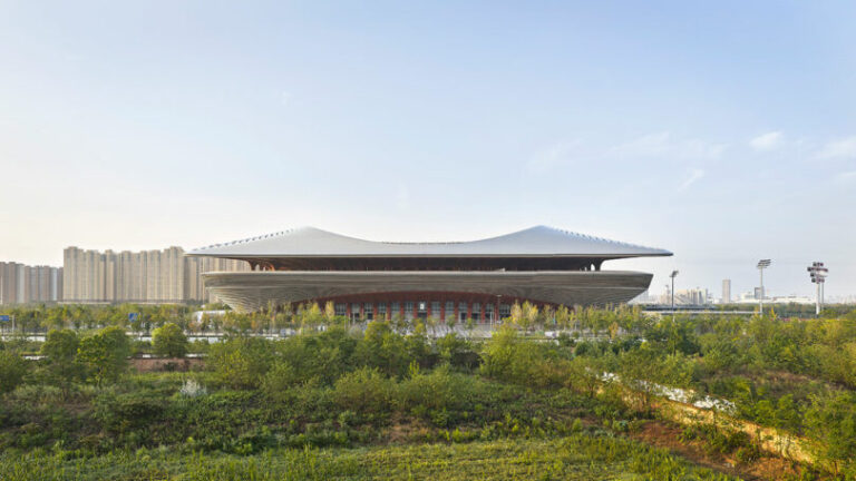 A Football Stadium With Fluid Forms Rises Above in China