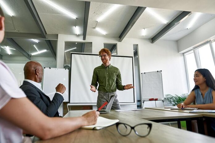 leader-talks-to-his-team-members-during-a-work-meeting.jpg