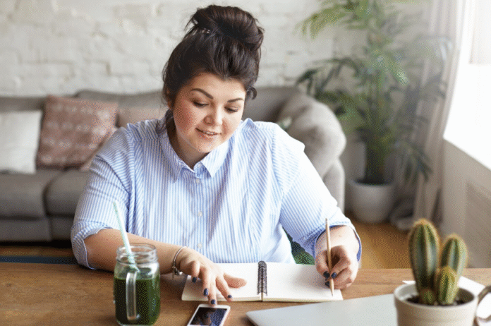 woman-writing-on-a-desk.png